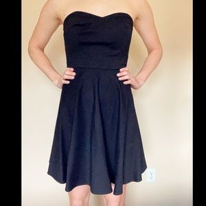 Sweetheart neckline black strapless dress.